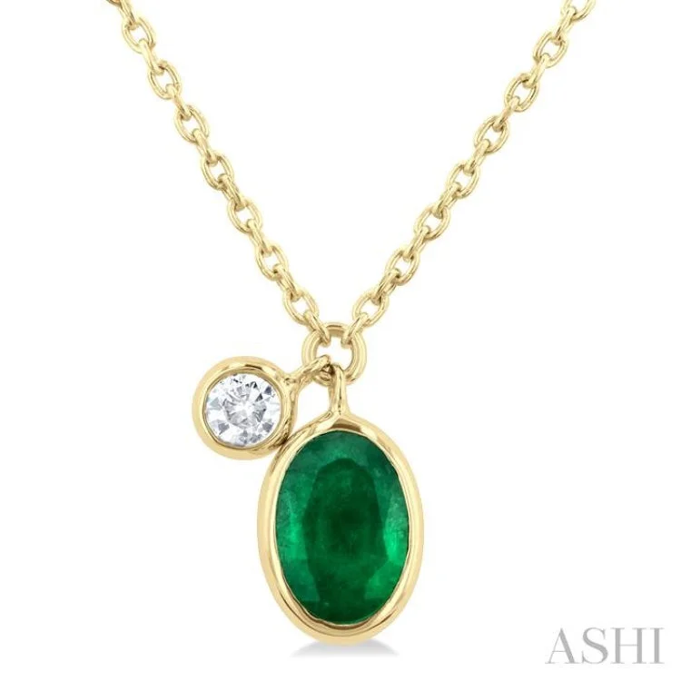 1/20 ctw Oval Cut 6X4MM Emerald and Bezel Set Round Cut Diamond Precious Necklace in 14K Yellow Gold